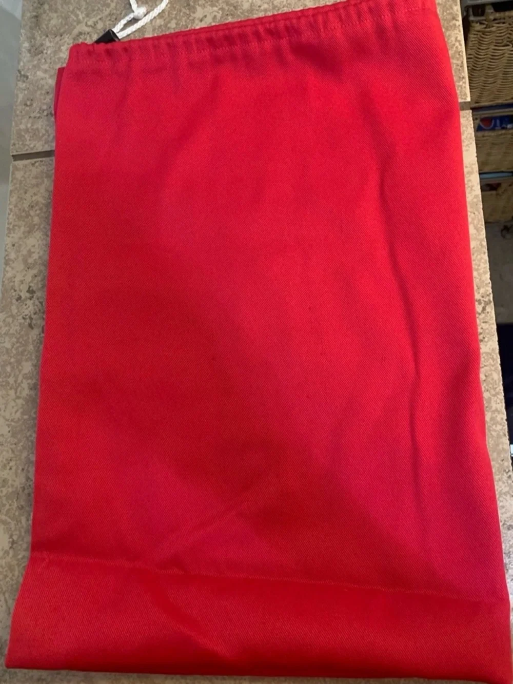 Solid Red Drawstring Laundry Bag. Made of Fabric and White drawstring closure.
